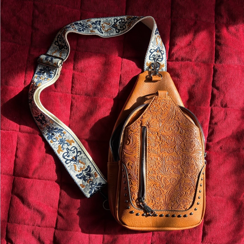 Embossed Leather Crossbody Bag with Patterned Strap